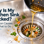 Kitchen sink with food scraps and cooking grease near the drain